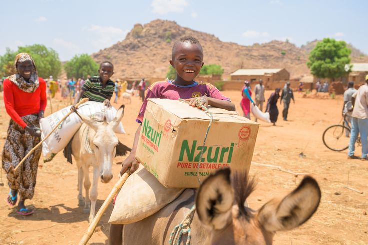 Child receiving food aid in Sudan